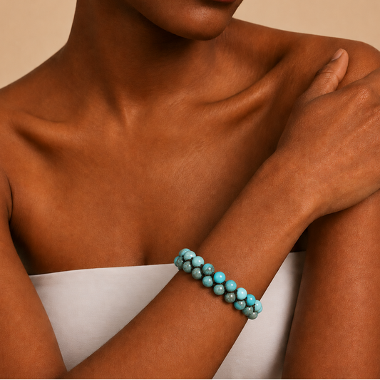 Azure Knot Bracelet worn on the wrist, with two rows of turquoise-coloured round beads on dark cord