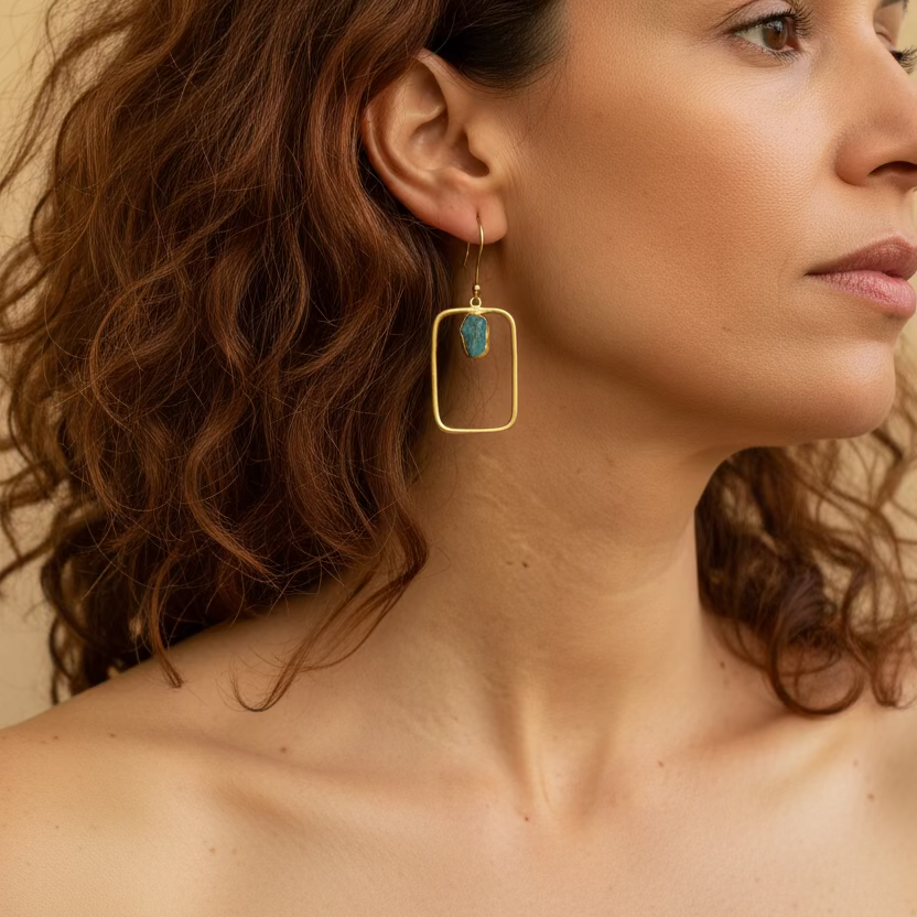 Blue Frame Earrings worn on the ear, with open rectangular frames and small blue stone accents