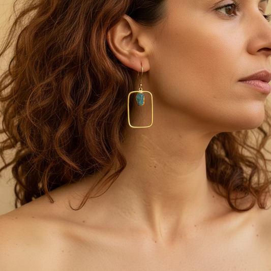 Blue Frame Earrings worn on the ear, with open rectangular frames and small blue stone accents