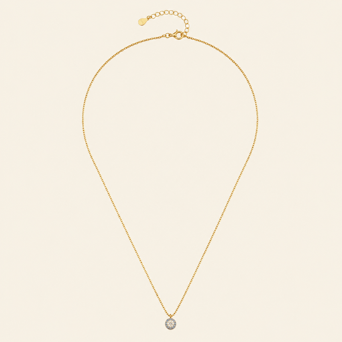Blue Halo Necklace with a round pendant with blue and clear stone accents in gold finish