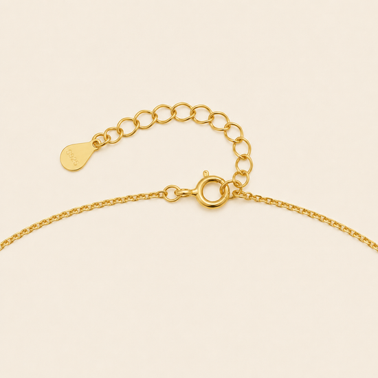 Blue Halo Necklace with a round pendant with blue and clear stone accents in gold finish