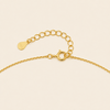 Blue Halo Necklace with a round pendant with blue and clear stone accents in gold finish