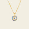 Blue Halo Necklace with a round pendant with blue and clear stone accents in gold finish