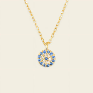 Blue Halo Necklace with a round pendant with blue and clear stone accents in gold finish