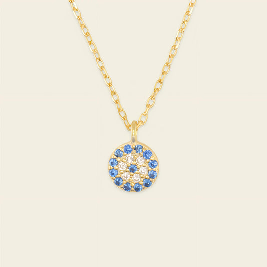 Blue Halo Necklace with a round pendant with blue and clear stone accents in gold finish