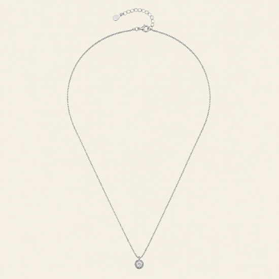 Blue Halo Necklace with a round pendant with blue and clear stone accents in silver finish