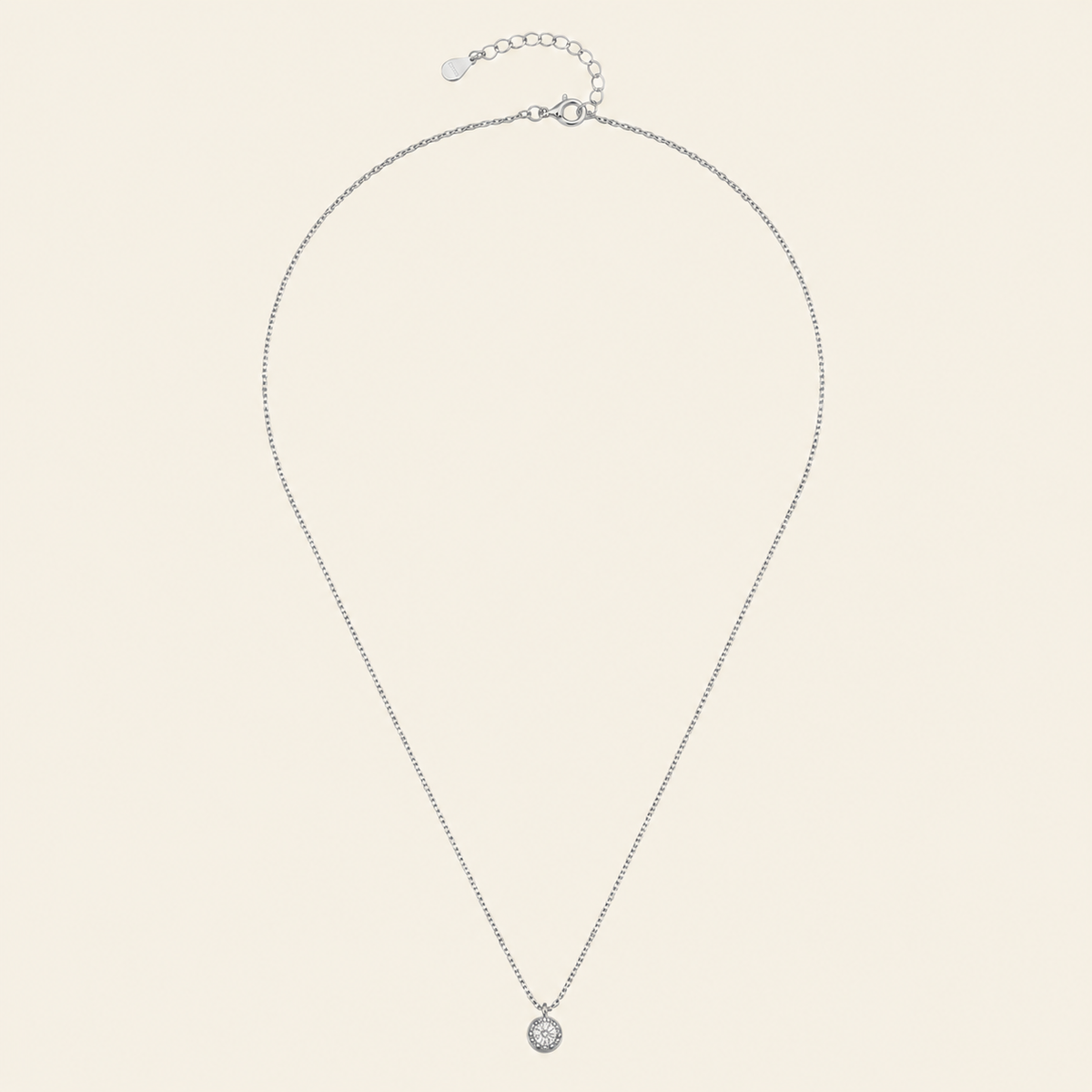 Blue Halo Necklace with a round pendant with blue and clear stone accents in silver finish