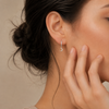 Celestial Light Earrings worn on the ear in gold finish