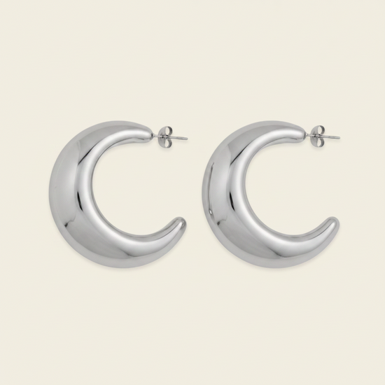 Crescent Sweep Earrings with broad polished crescent-shaped hoops in silver finish