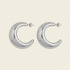 Crescent Sweep Earrings with broad polished crescent-shaped hoops in silver finish