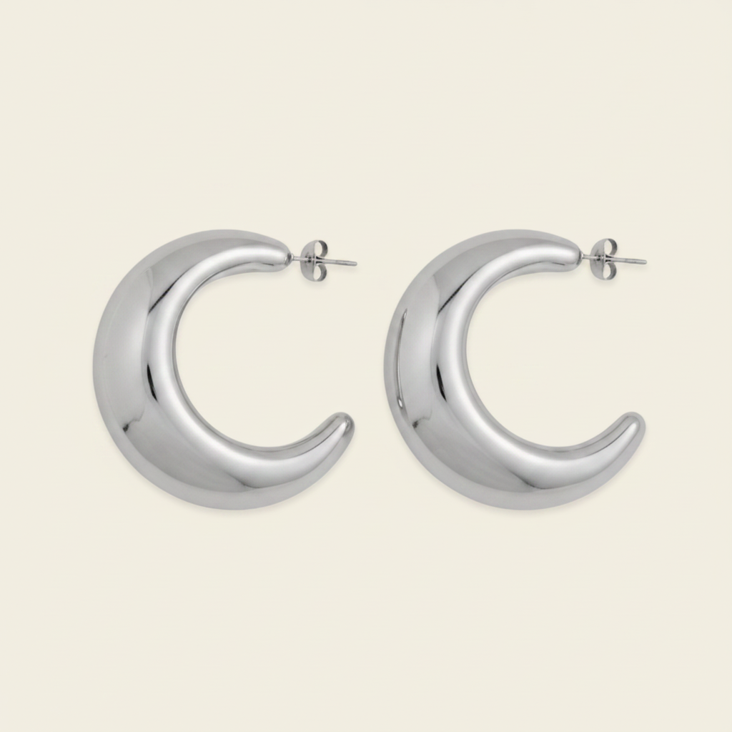 Crescent Sweep Earrings with broad polished crescent-shaped hoops in silver finish