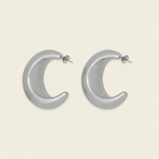 Crescent Sweep Earrings with broad polished crescent-shaped hoops in silver finish