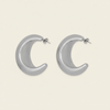 Crescent Sweep Earrings with broad polished crescent-shaped hoops in silver finish