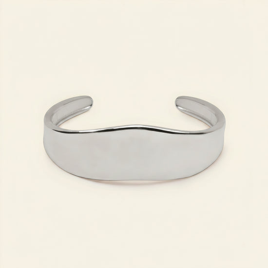 Crest Band Cuff with a broad polished band with a wavy edge in silver finish