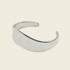 Crest Band Cuff with a broad polished band with a wavy edge in silver finish