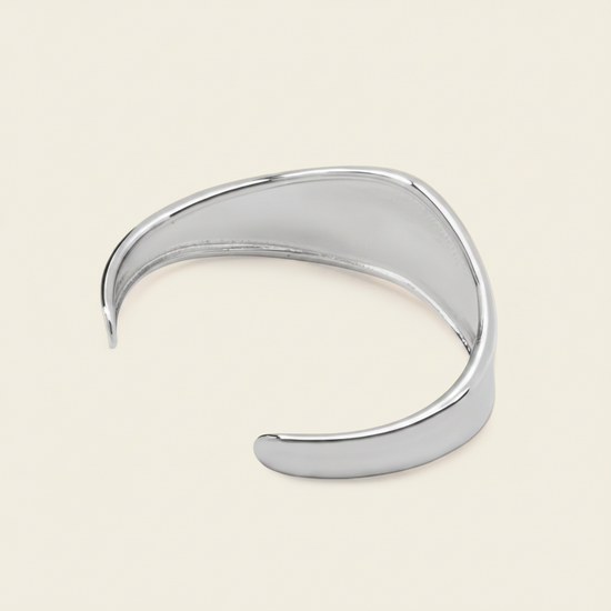 Crest Band Cuff with a broad polished band with a wavy edge in silver finish