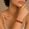Crimson Knot Bracelet worn on the wrist, with two rows of round beads woven onto contrasting cord