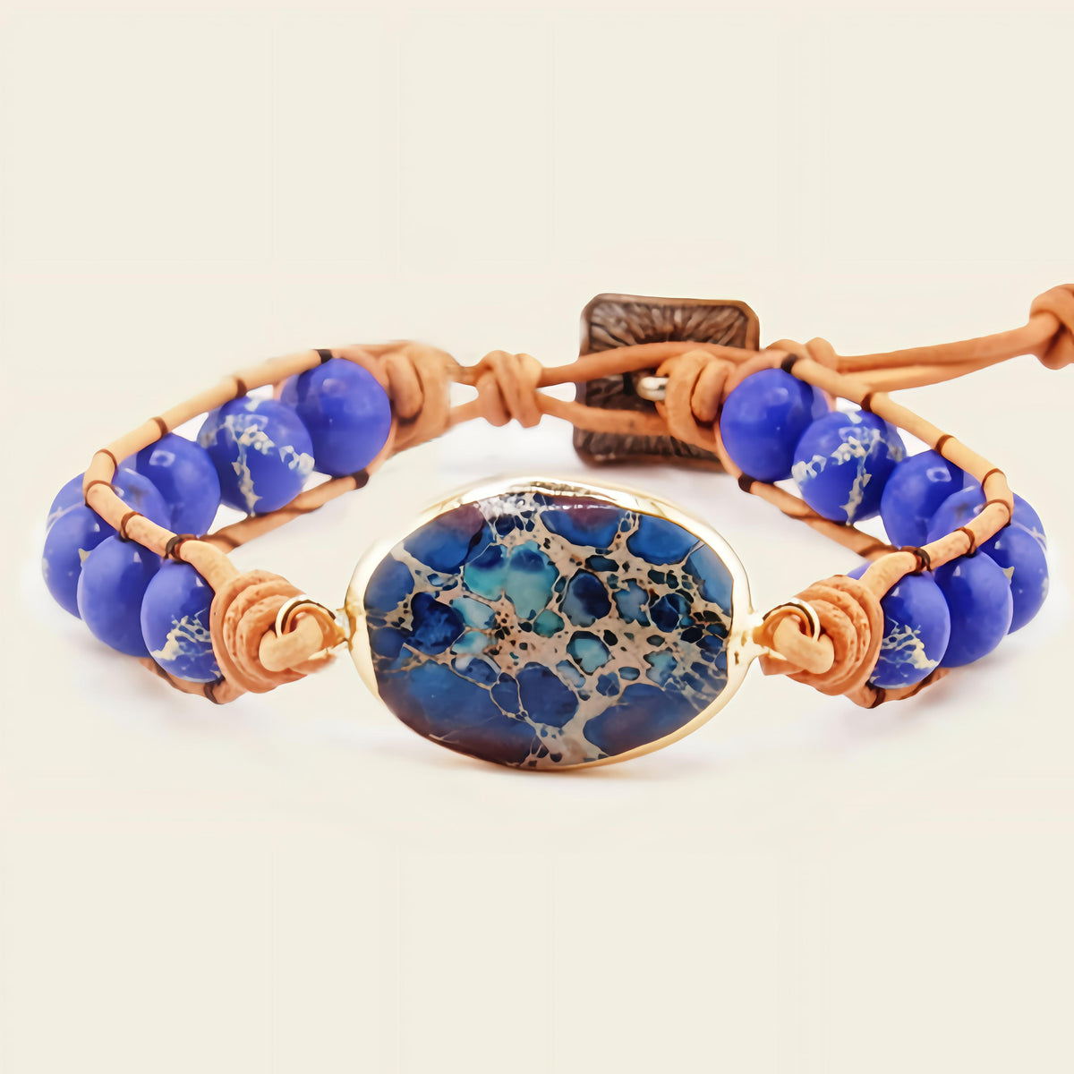 Deep Tide Bracelet with blue stone beads and an oval patterned centre