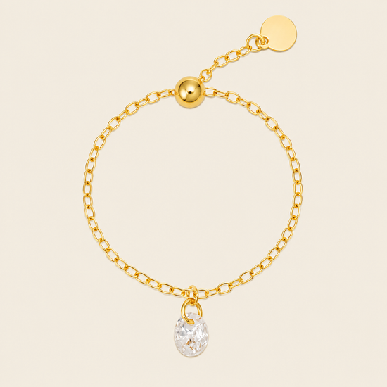 Dewdrop Chain Ring with an adjustable chain band and clear teardrop charm in gold finish