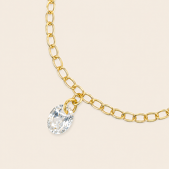 Dewdrop Chain Ring with an adjustable chain band and clear teardrop charm in gold finish