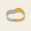 Dual Sweep Cuff with a broad two-tone curved band in gold and silver finish