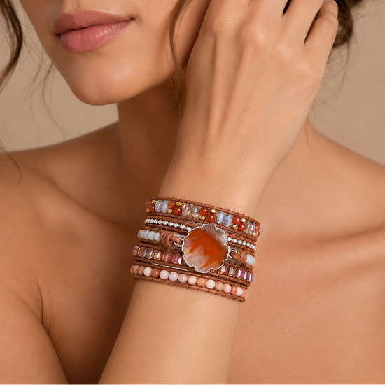 Ember Form Bracelet worn on the wrist, with layered orange and pale stone beads