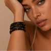 Field Line Bracelet worn on the wrist, with black and brown round bead strands