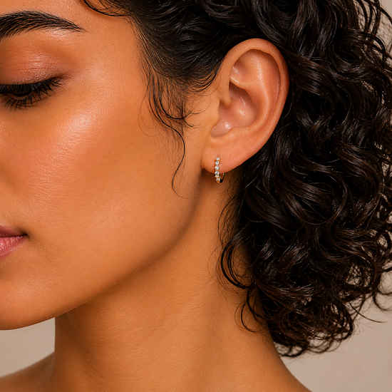 Fine Light Earrings worn on the ear in gold finish