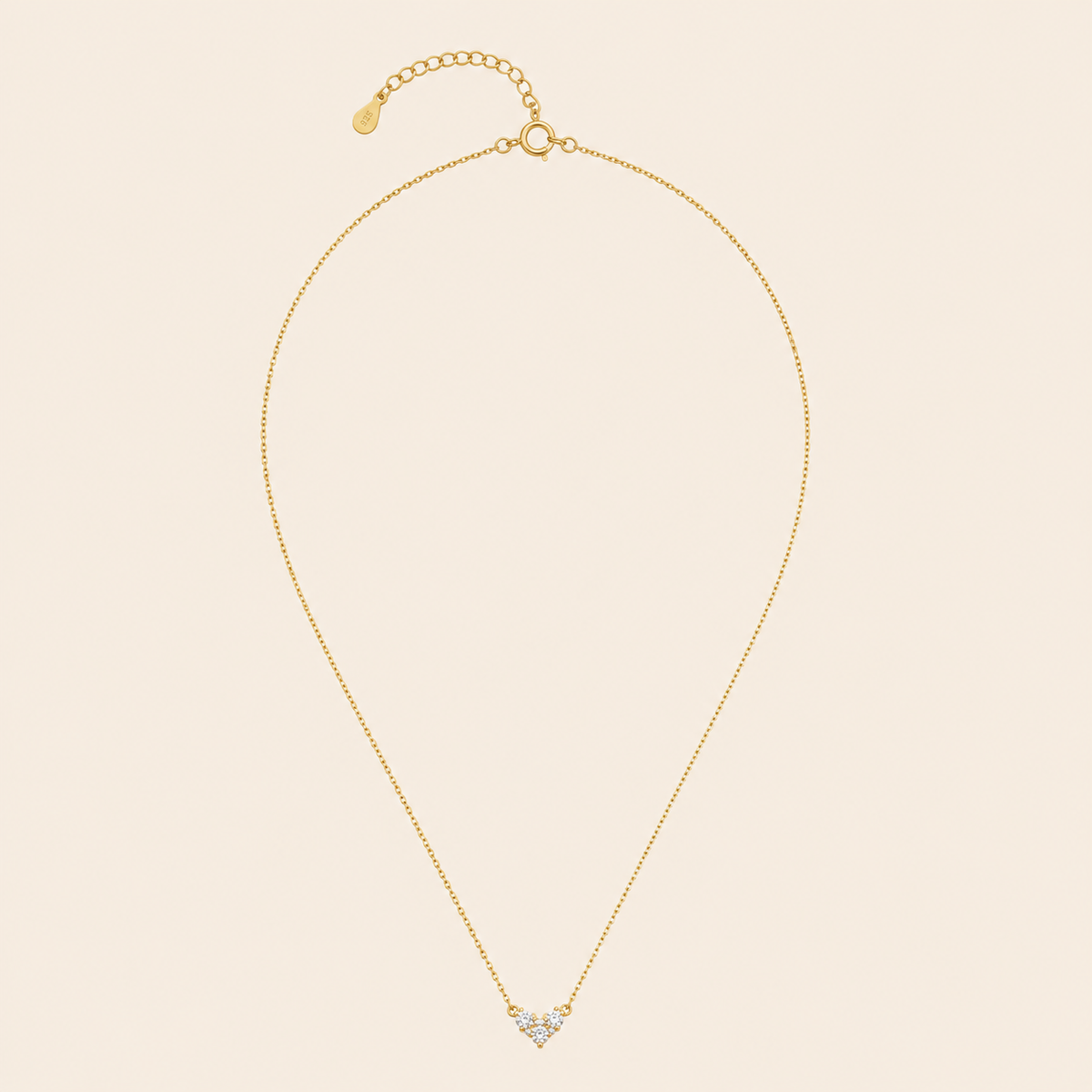 Fine Trio Necklace with a small triangular cluster of clear stones in gold finish