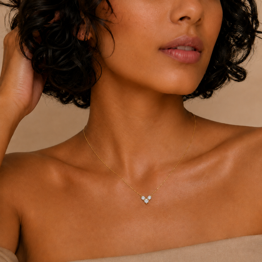 Fine Trio Necklace worn at the neckline in gold finish