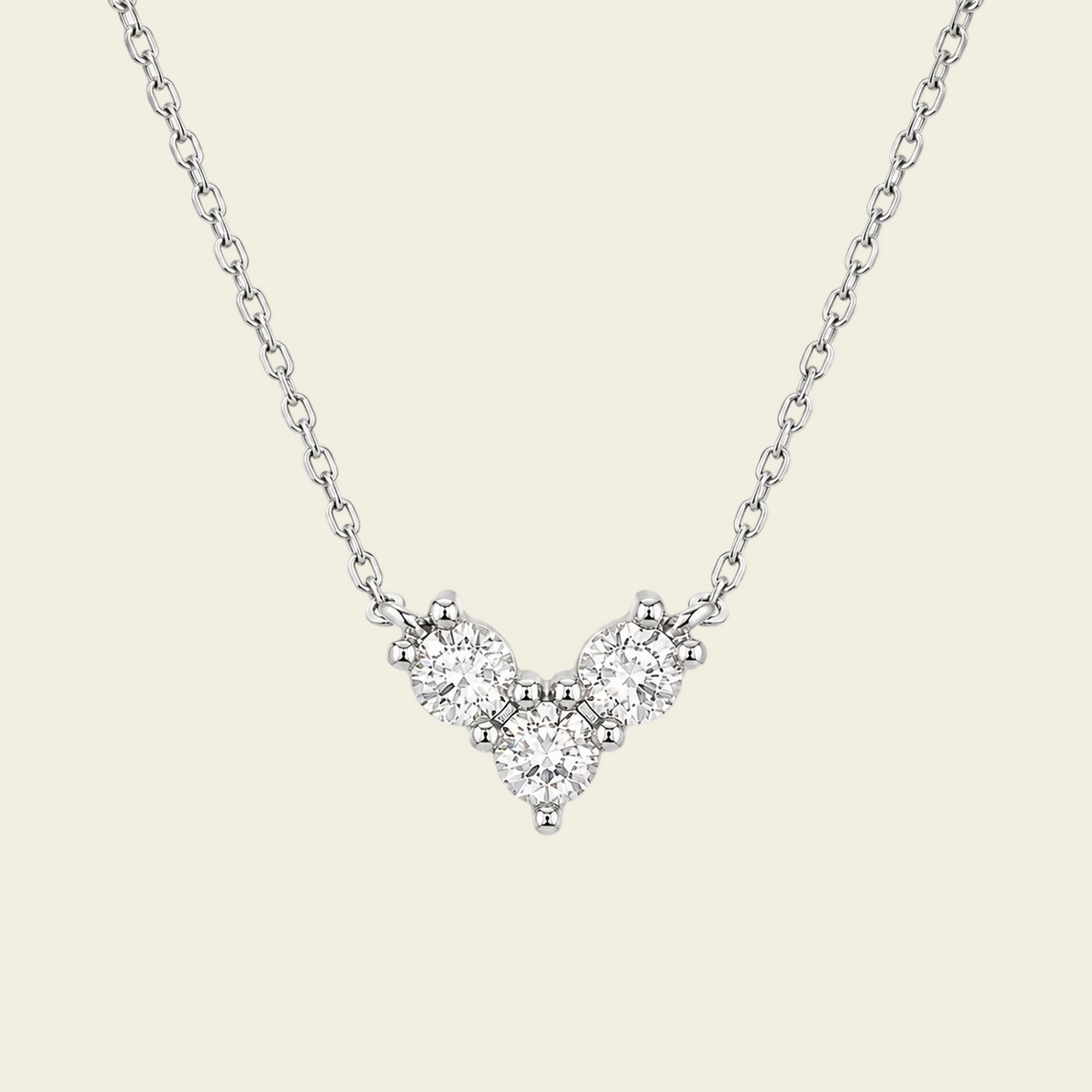Fine Trio Necklace with a small triangular cluster of clear stones in silver finish