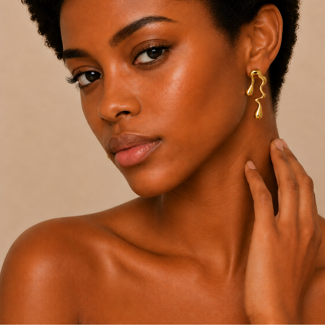 Flowing Line Earrings worn on the ear in gold finish