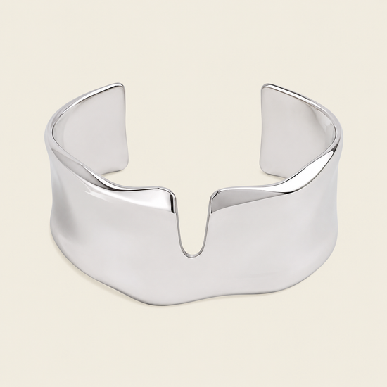 Fluid Edge Cuff with a broad polished open band with notched edges in gold finish