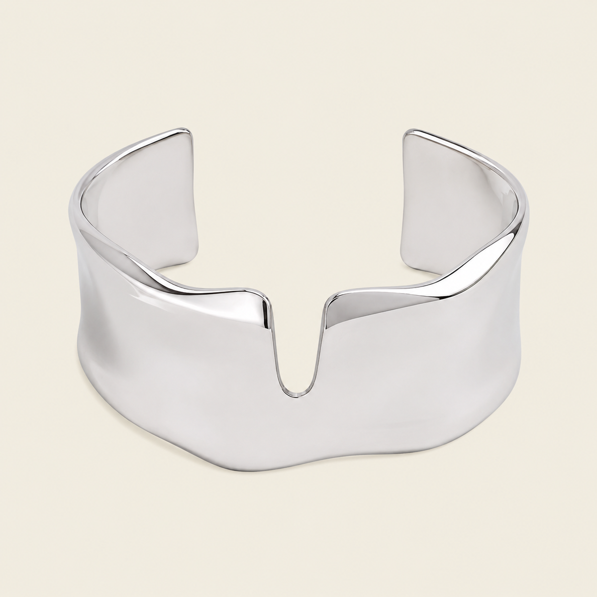 Fluid Edge Cuff with a broad polished open band with notched edges in gold finish