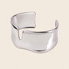 Fluid Edge Cuff with a broad polished open band with notched edges in gold finish