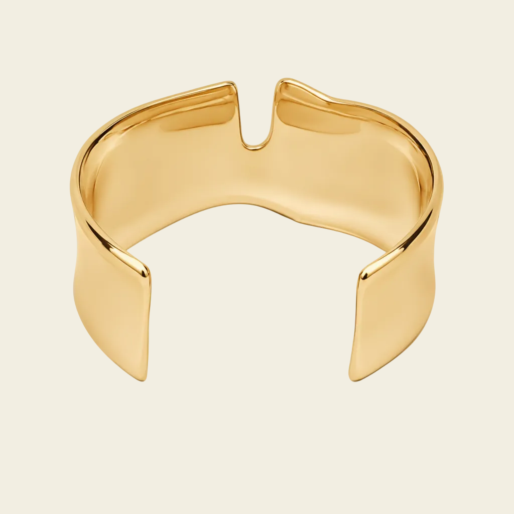 Fluid Edge Cuff with a broad polished open band with notched edges in gold finish