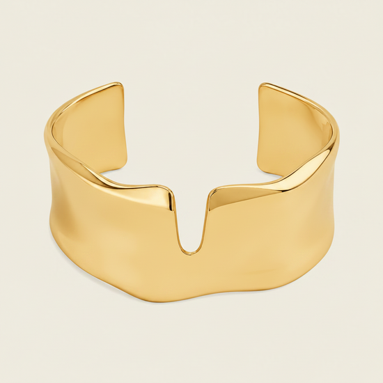 Fluid Edge Cuff with a broad polished open band with notched edges in gold finish