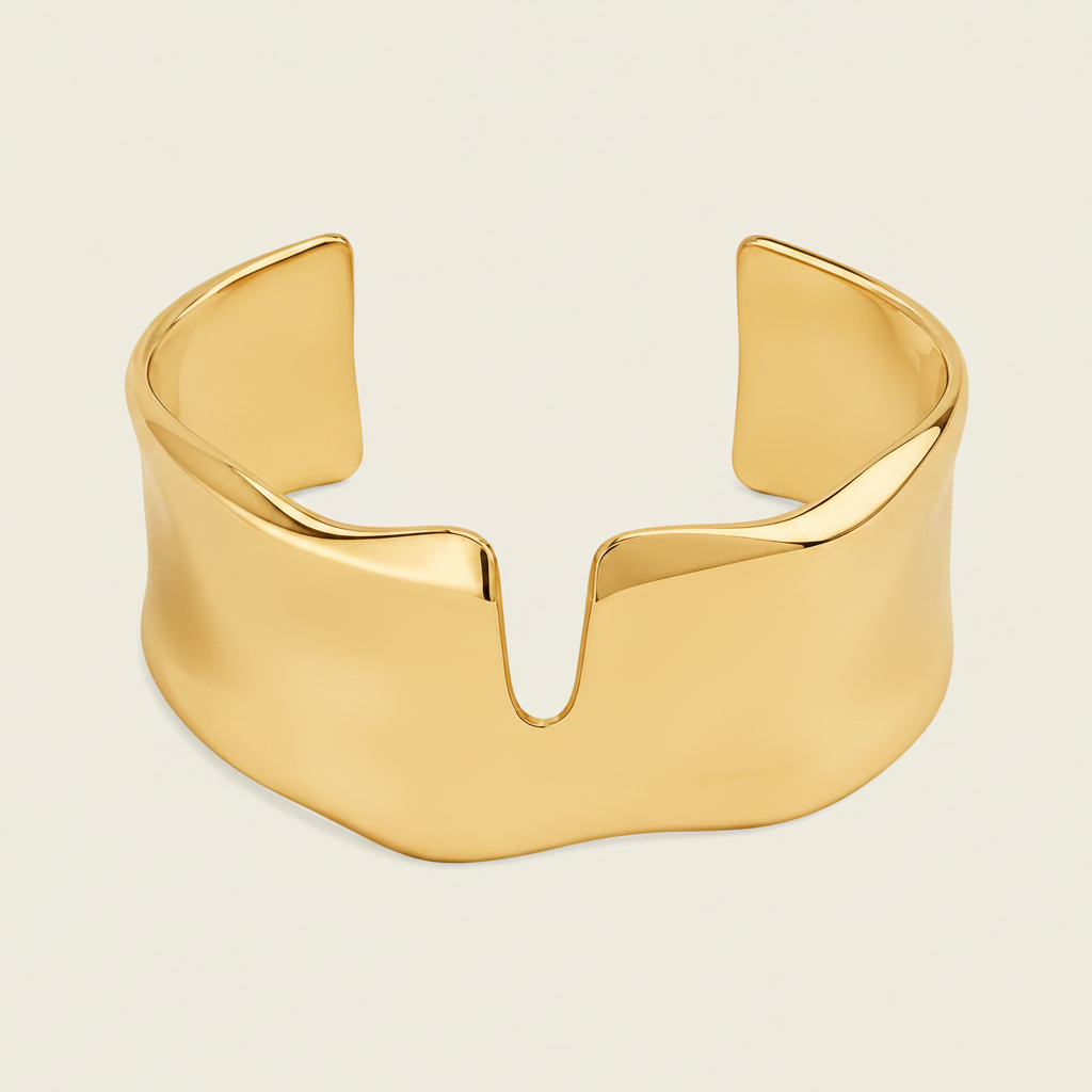 Fluid Edge Cuff with a broad polished open band with notched edges in gold finish