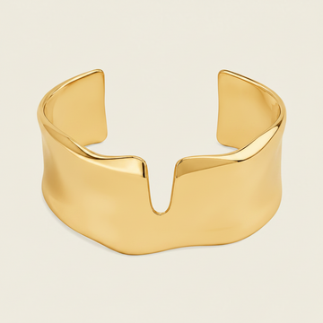 Fluid Edge Cuff with a broad polished open band with notched edges in gold finish