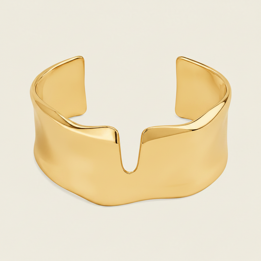 Fluid Edge Cuff with a broad polished open band with notched edges in gold finish
