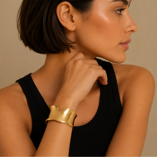 Fluid Edge Cuff worn on the wrist in gold finish