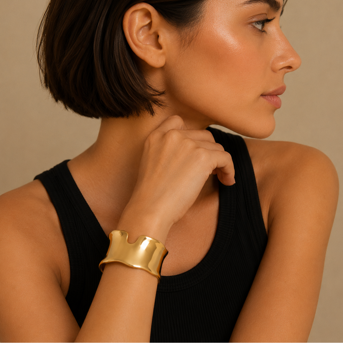 Fluid Edge Cuff worn on the wrist in gold finish