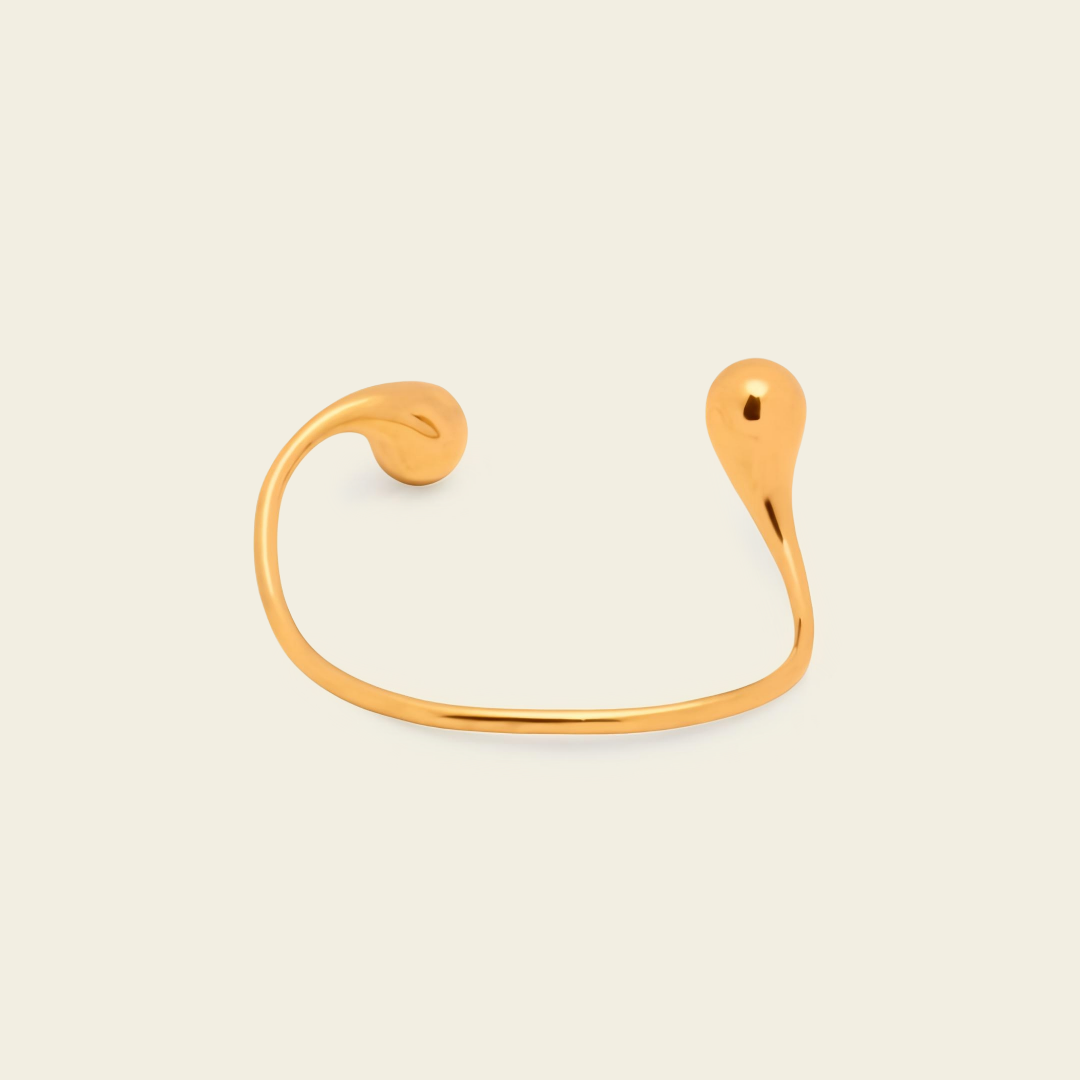 Fluid Teardrop Cuff with an open band with unequal teardrop ends in gold finish