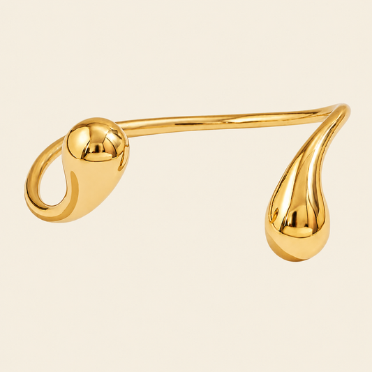 Fluid Teardrop Cuff with an open band with unequal teardrop ends in gold finish