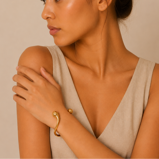Fluid Teardrop Cuff worn on the wrist in gold finish