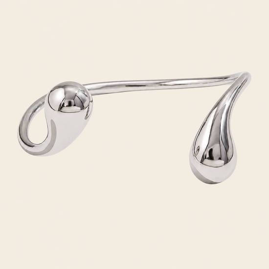 Fluid Teardrop Cuff with an open band with unequal teardrop ends in silver finish