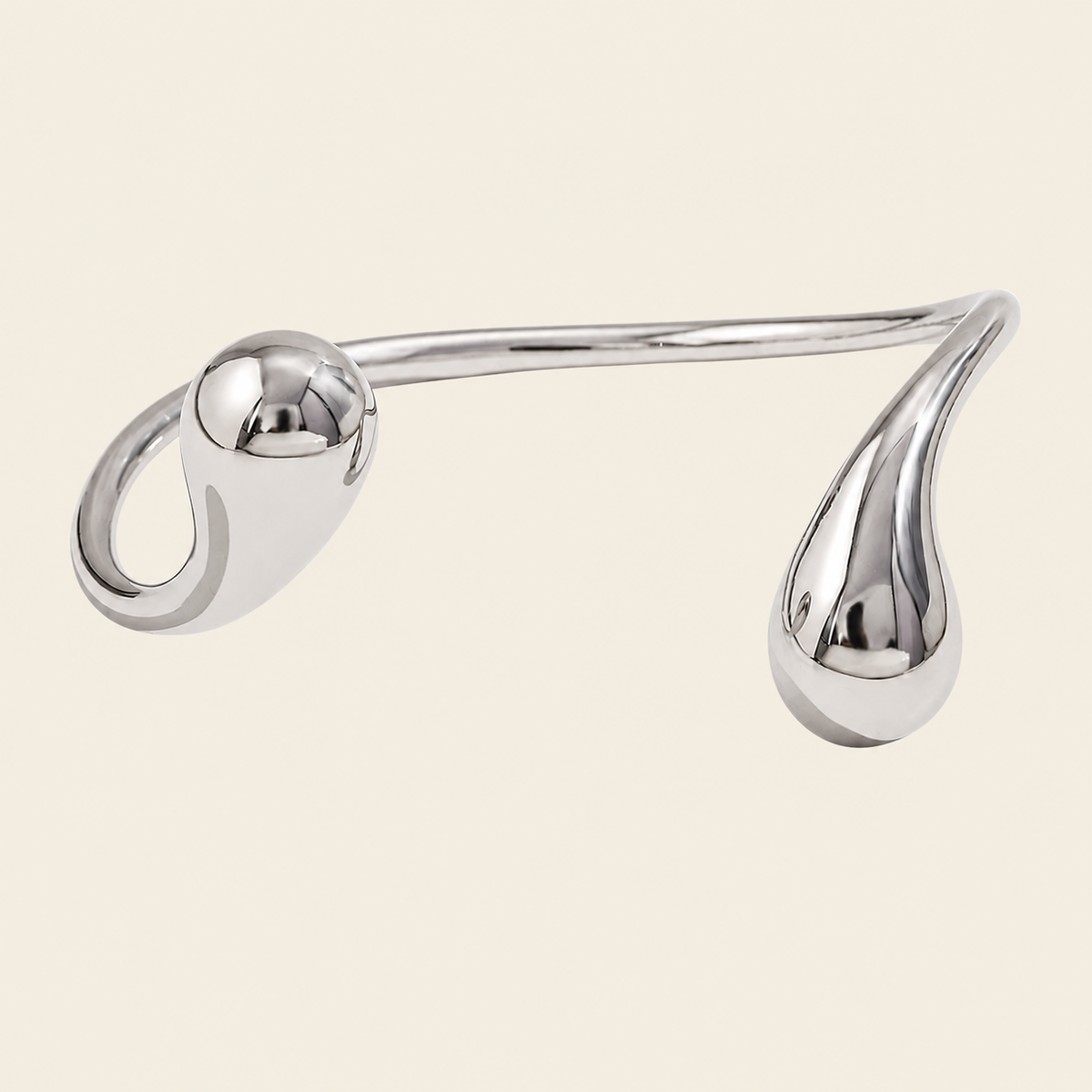 Fluid Teardrop Cuff with an open band with unequal teardrop ends in silver finish