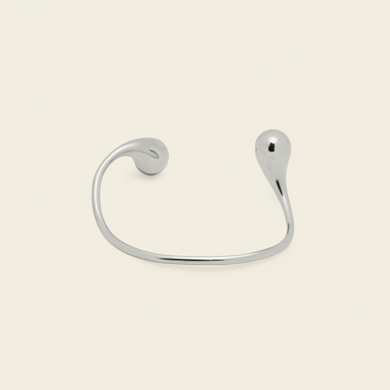 Fluid Teardrop Cuff with an open band with unequal teardrop ends in silver finish