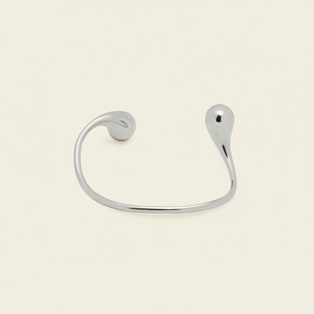Fluid Teardrop Cuff with an open band with unequal teardrop ends in silver finish