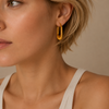 Fluted Arc Earrings worn on the ear in gold finish